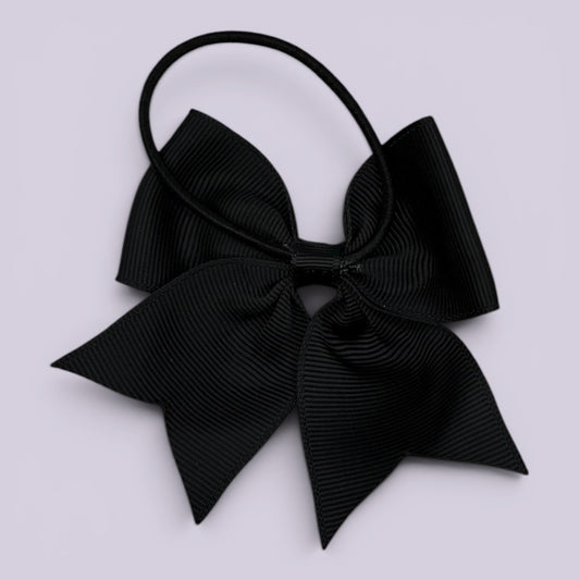 Black four tailed bow bobble on card