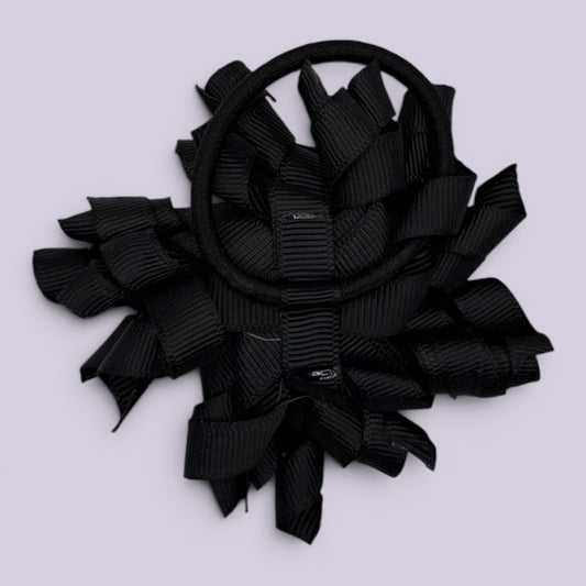 Black korker bow bobble on card