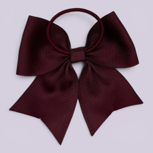 Burgundy maroon four tailed bow bobble on card
