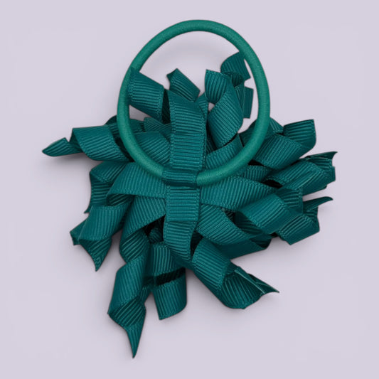 Jade green korker bow bobble on card