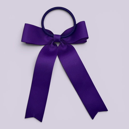 Purple tailed bow bobble on card