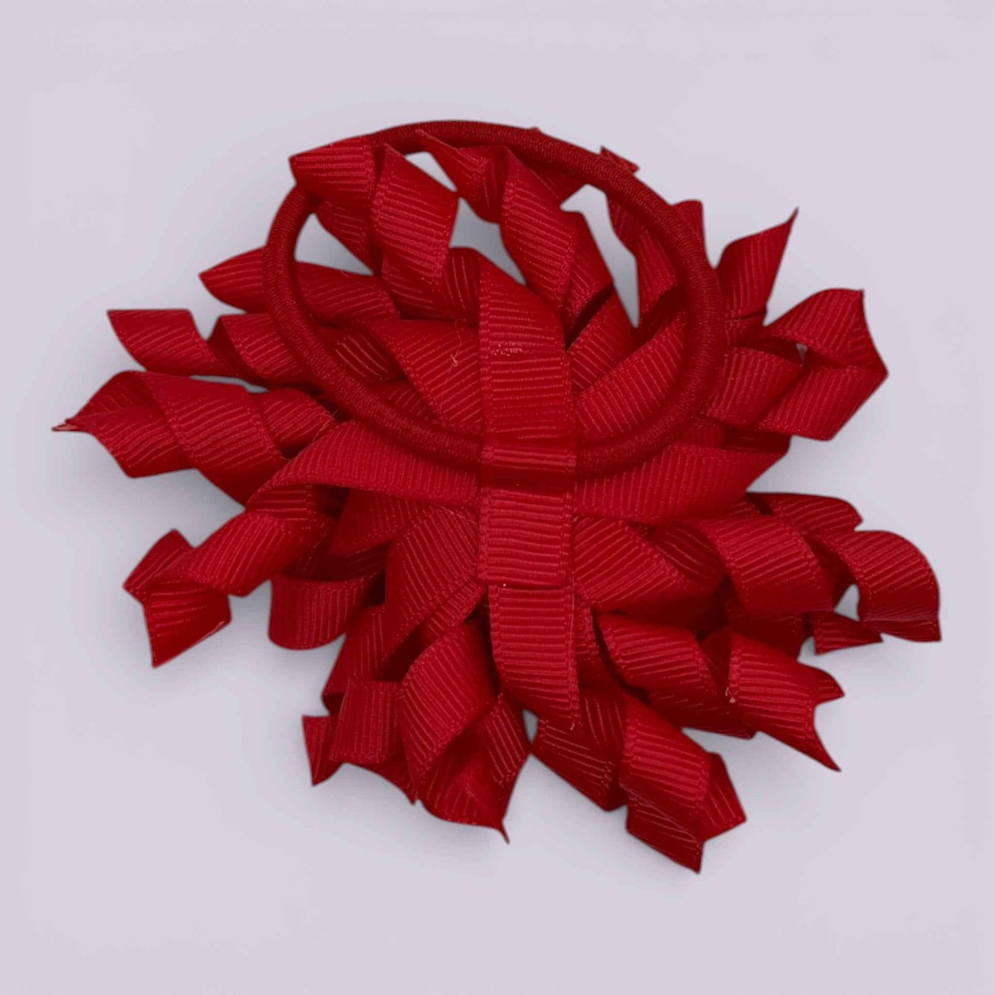 Red korker bow bobble on card