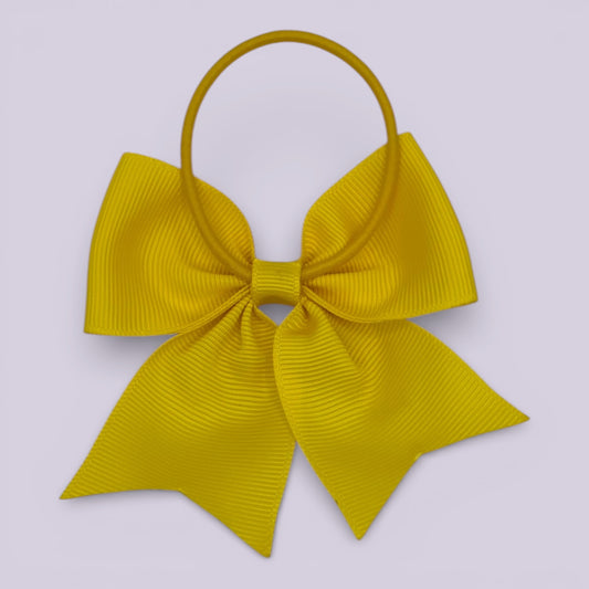 Yellow four tailed bow bobble on card