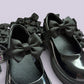 Black shoe bows on school uniform shoes