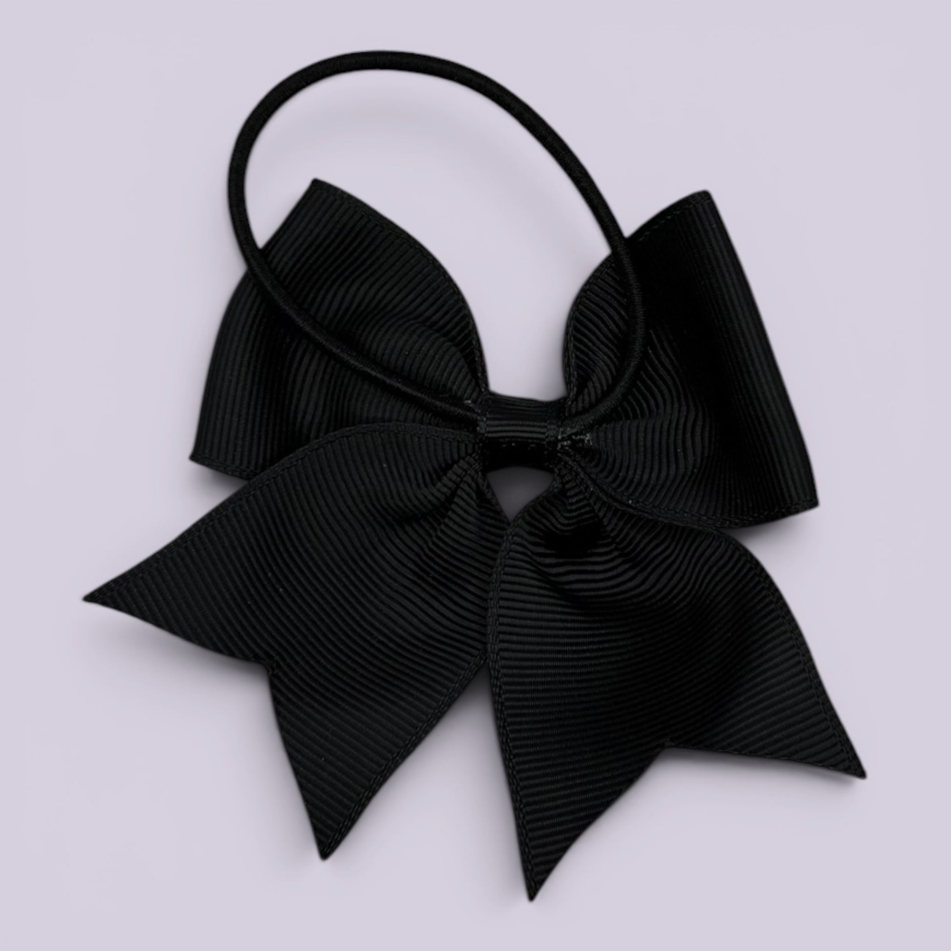 Black four tailed bow bobble on card
