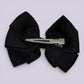 Black pinwheel bow clip on card