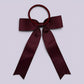 Burgundy maroon tailed bow bobble on card
