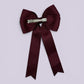 Burgundy maroon tailed bow clip on card