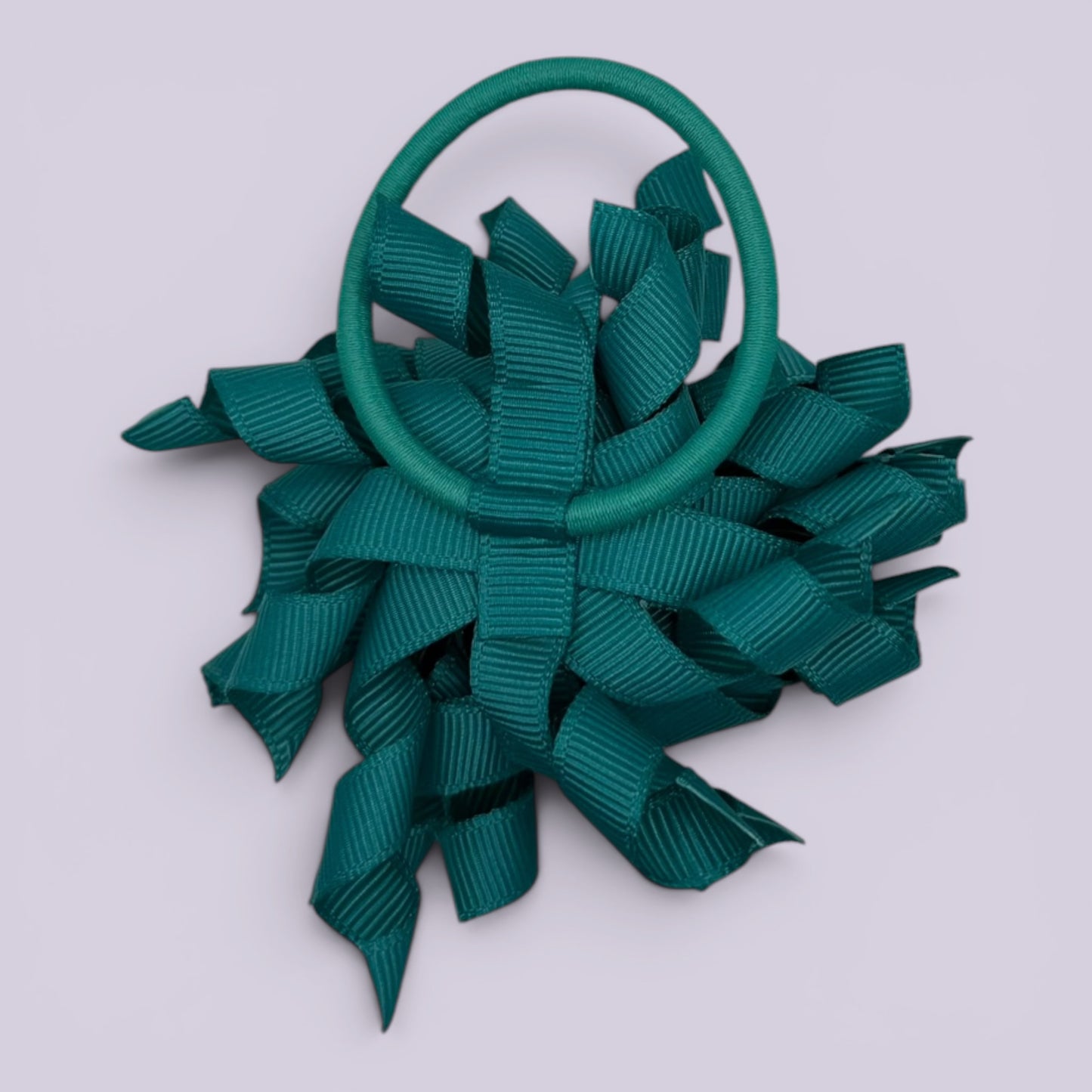 Jade green korker bow bobble on card
