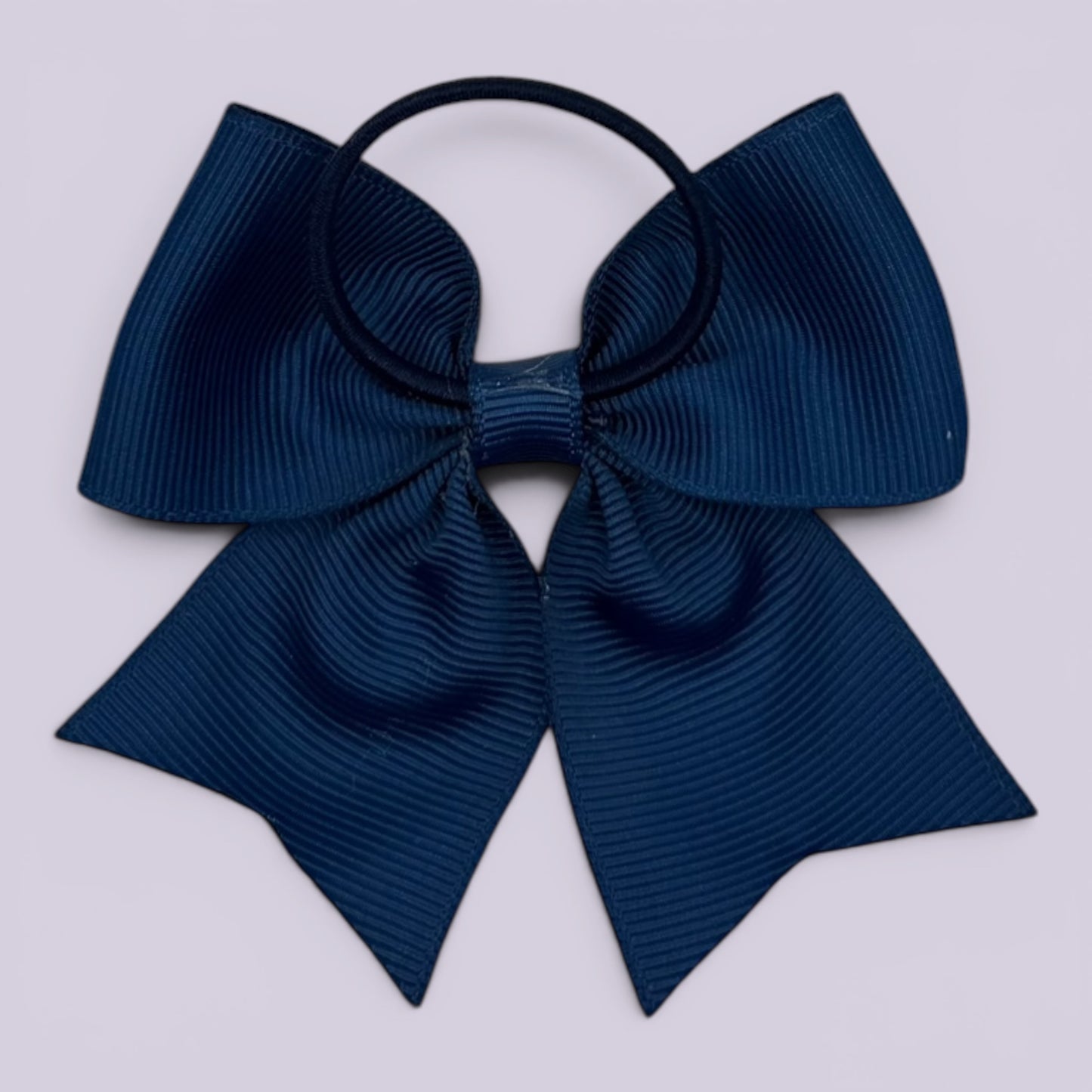 Navy blue four tailed bow bobble on card
