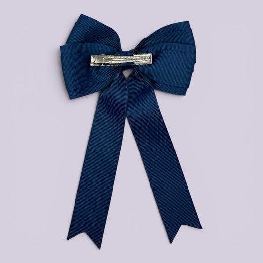 Navy blue tailed bow clip on card