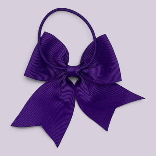 Purple four tailed bow bobble on card