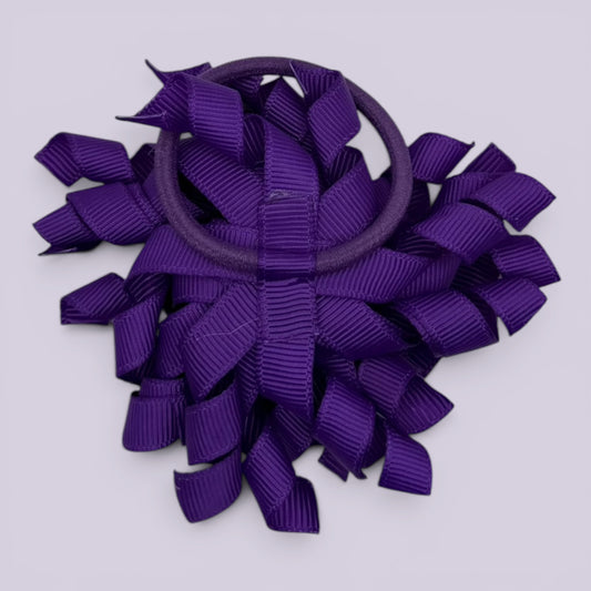 Purple korker bow bobble on card