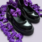 Purple shoe bows on school shoes