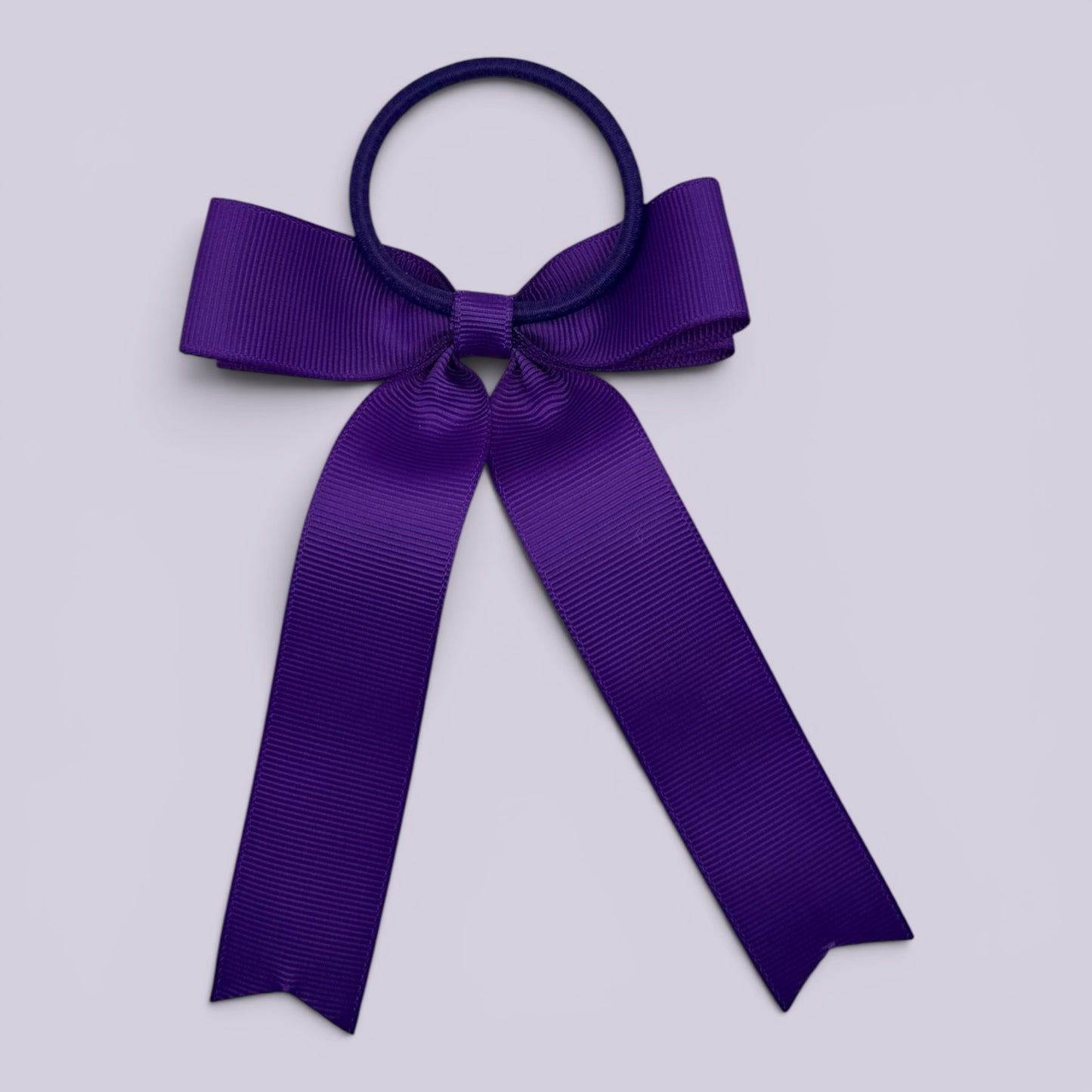 Purple tailed bow bobble on card