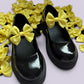 Yellow gingham shoe bows on school shoes
