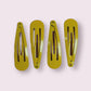 Yellow snap hair clips on card